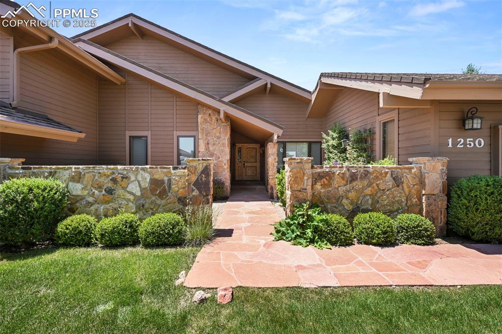 Image 2: View of exterior entry with stone siding