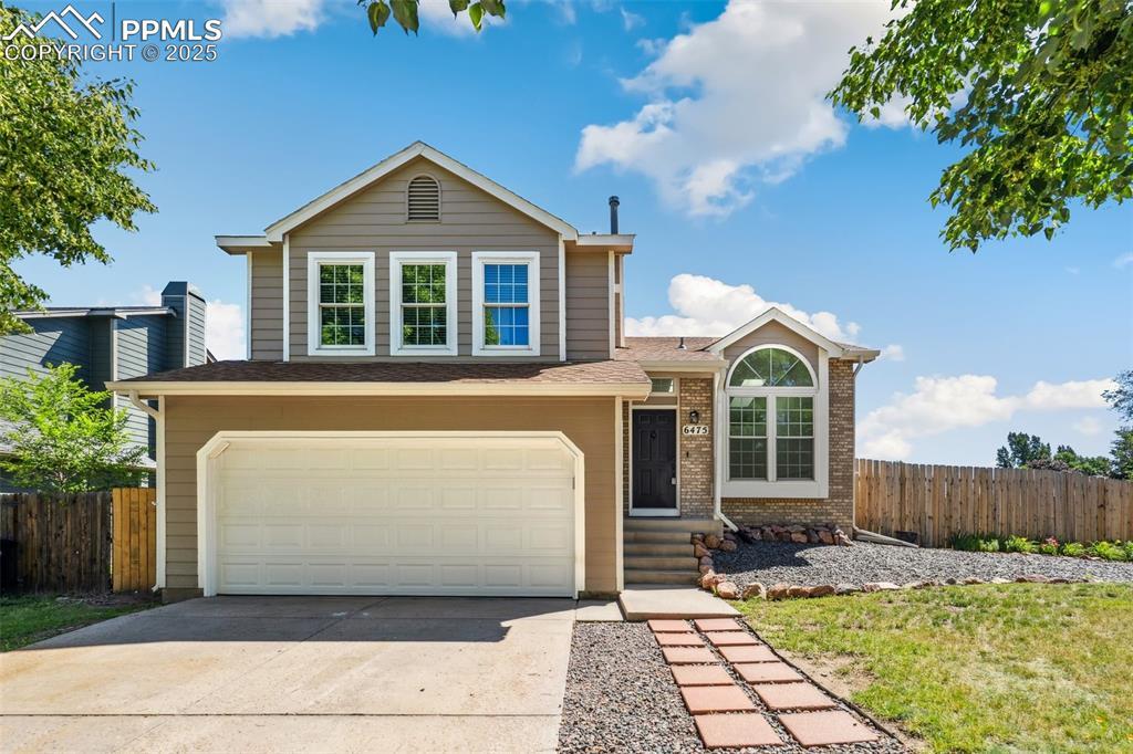 Image 1: Traditional home featuring an attached garage, brick siding, driveway, and roof with shingles