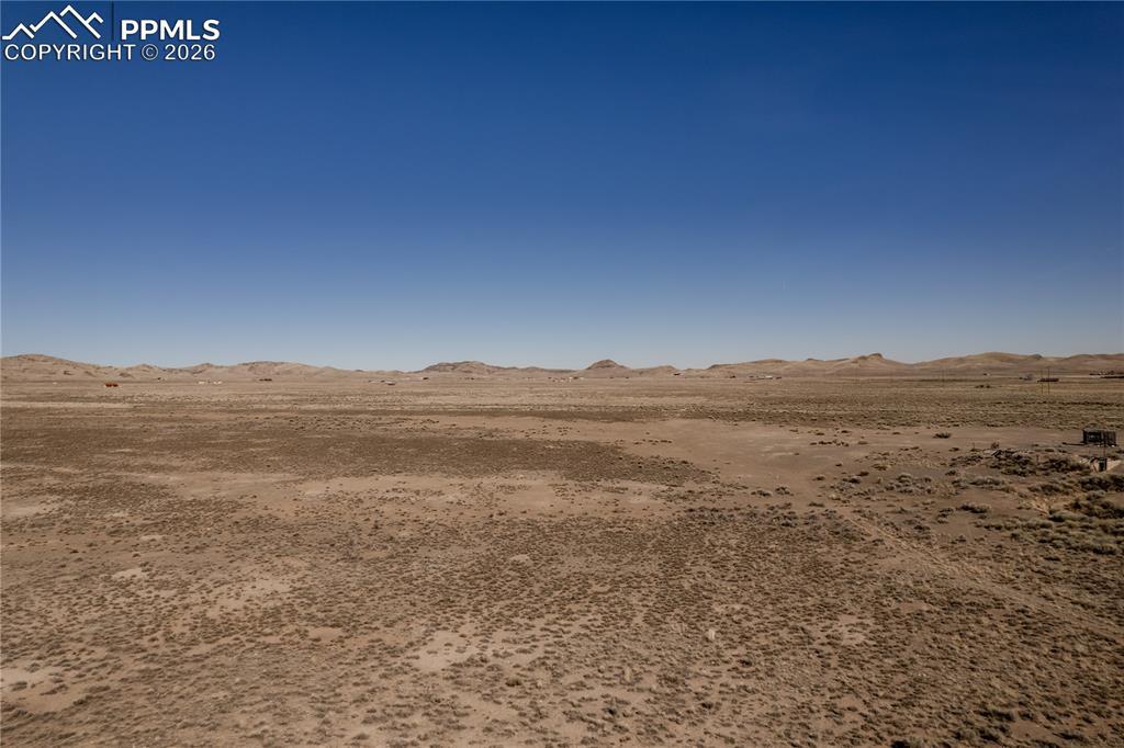 Image 2: View of nature with a mountain backdrop and a desert landscape