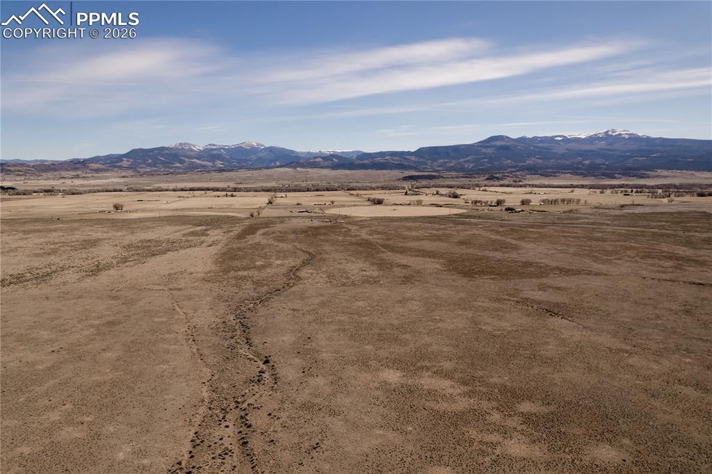 Image 4: View of mountain backdrop with rural landscape and a desert landscape