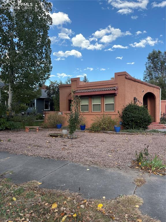 Image 1: View of front facade featuring stucco siding and a tiled roof