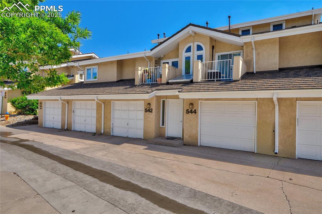 Image 2: Multi unit property featuring stucco siding and a balcony
