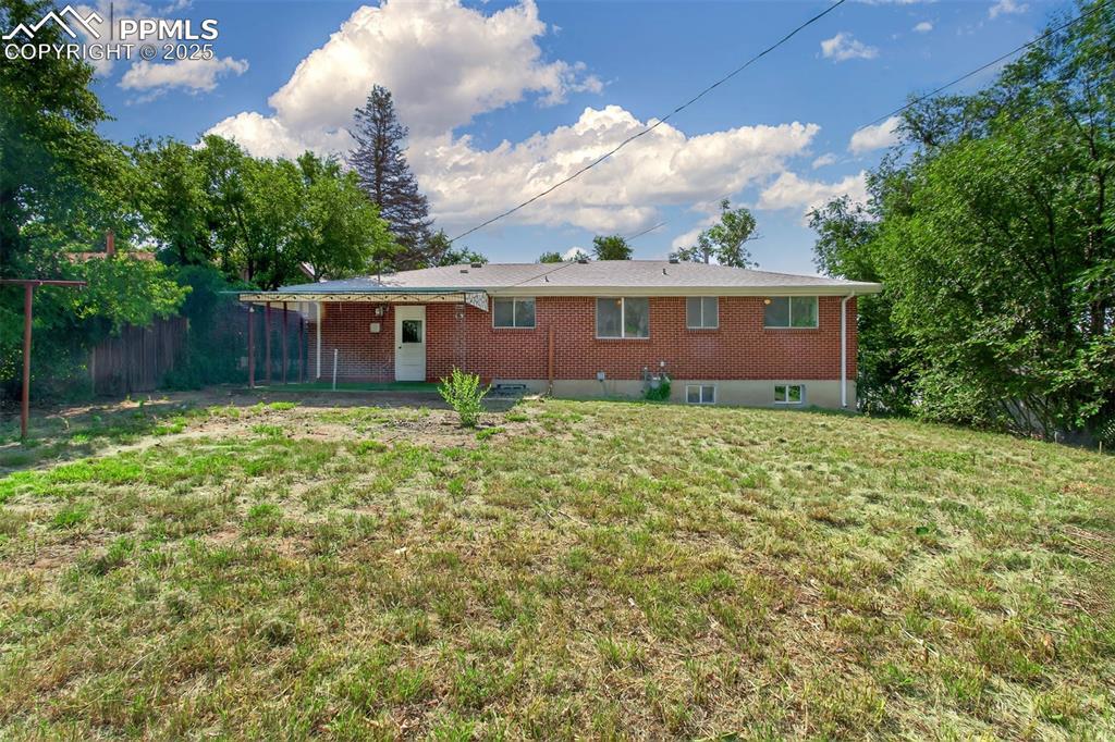 Image 2: Rear view of property with brick siding