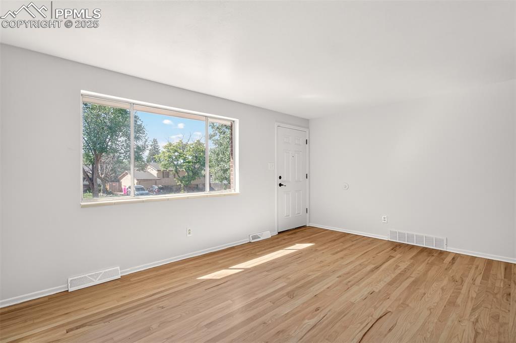 Image 3: Living room with light wood-style floors
