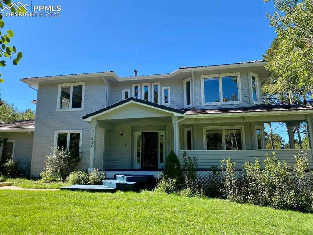 Image 1: View of front facade featuring covered porch (wood) and a front lawn