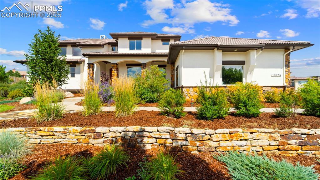 Image 2: View of front of property featuring stucco siding, a porch, and a tiled roof
