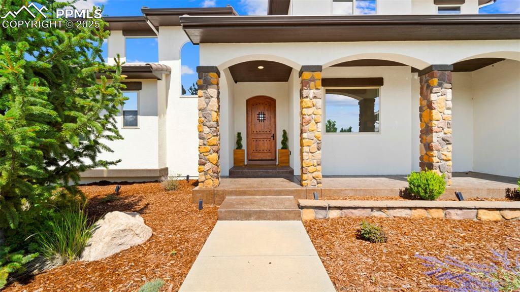 Image 4: Entrance to property featuring stucco siding