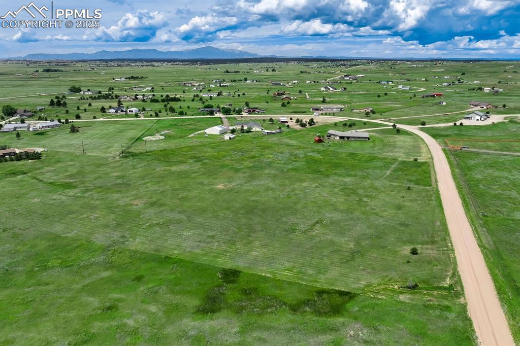 Image 1: Aerial view of sparsely populated area featuring a mountain backdrop