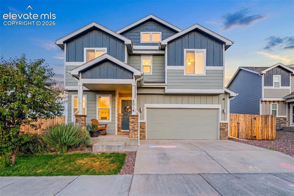 Image 1: Multi-level exterior featuring varied siding materials and stone accents