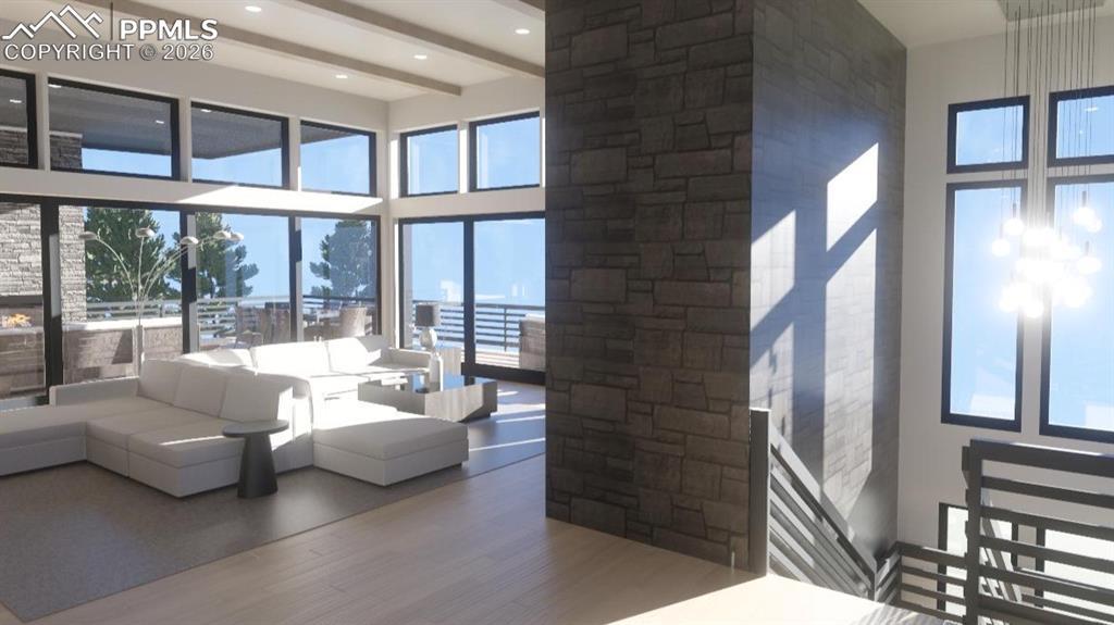 Image 3: Living area featuring a high ceiling, wood finished floors, and ceiling beams