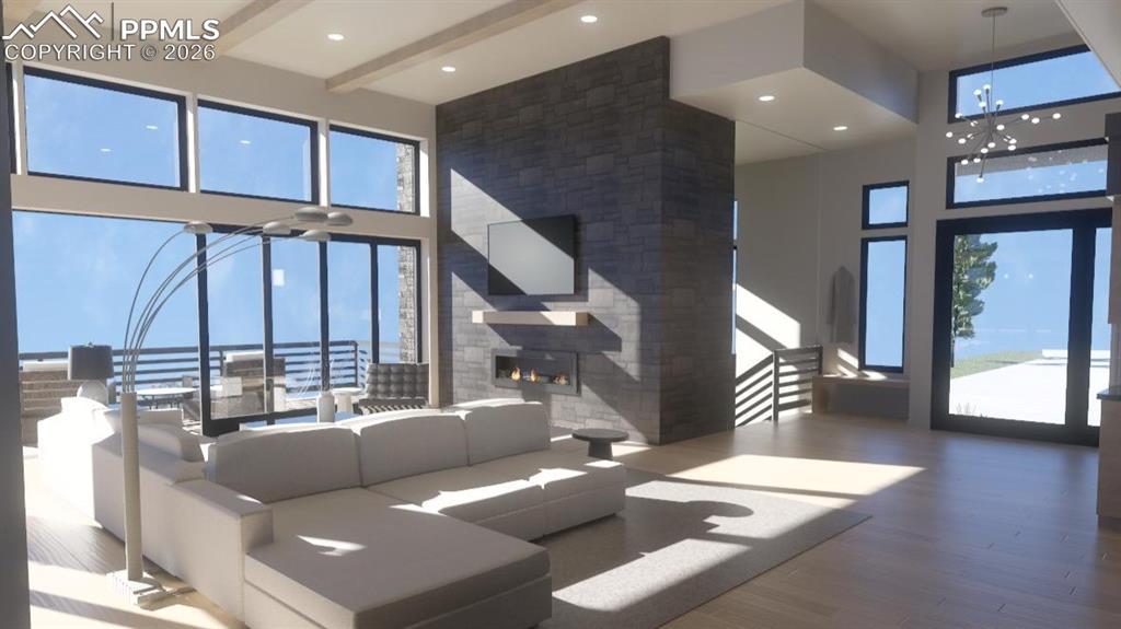 Image 4: Front entry with iron pivot door, stone gas linear fireplace