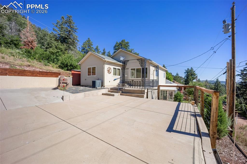 Image 4: View of front facade featuring a patio and a wooden deck