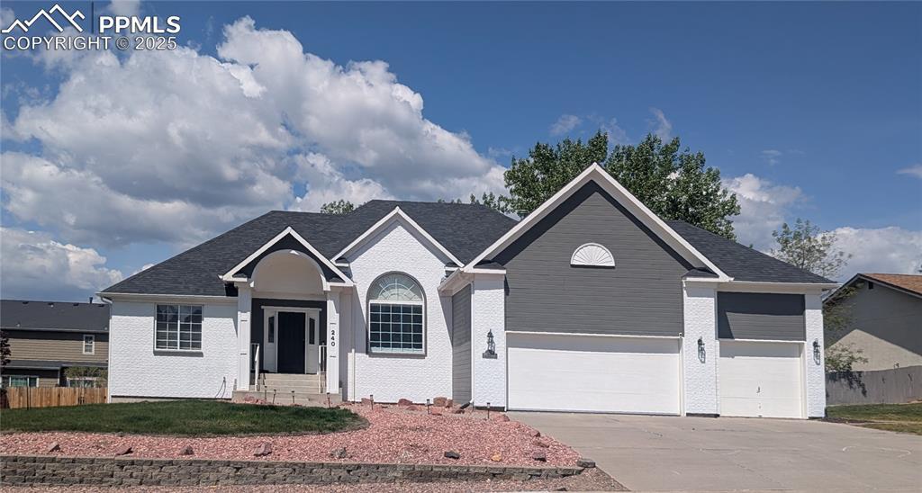 Image 1: Ranch-style house featuring driveway, entry steps, and an attached garage