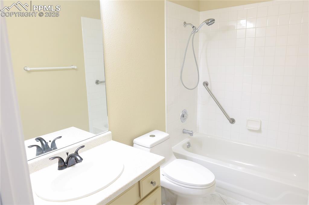 Image 4: Main level full bath with vanity and bathing tub / shower combination.