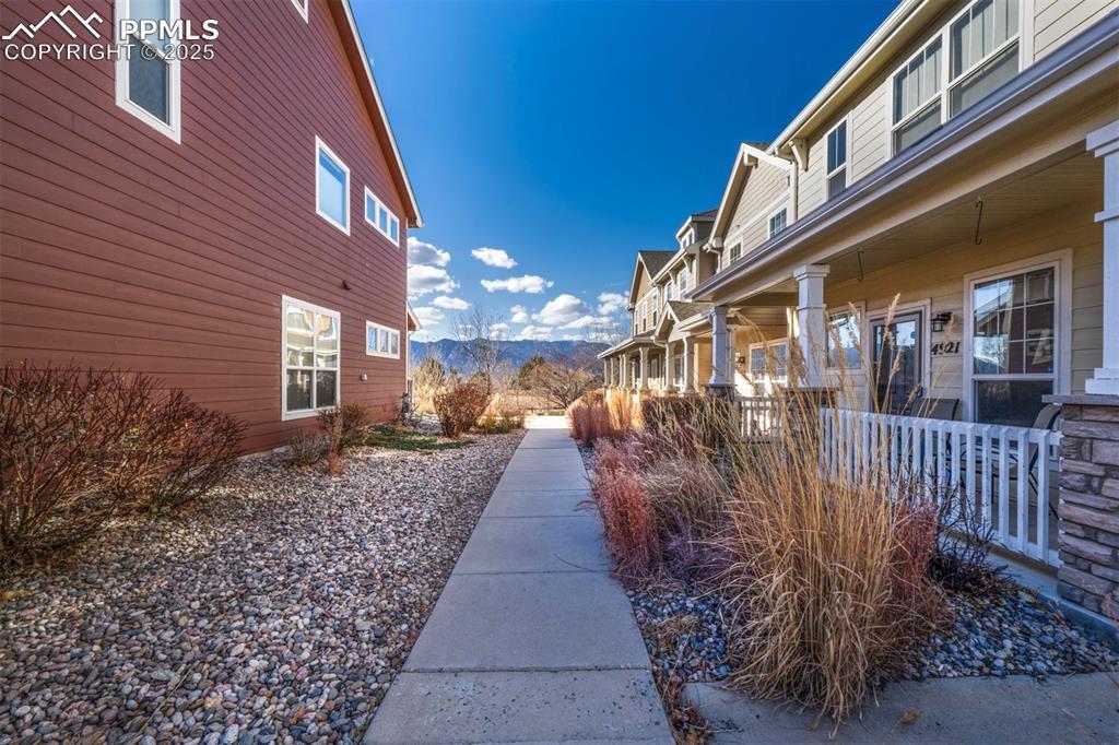 Image 3: View of home's community with a mountain view and covered porch