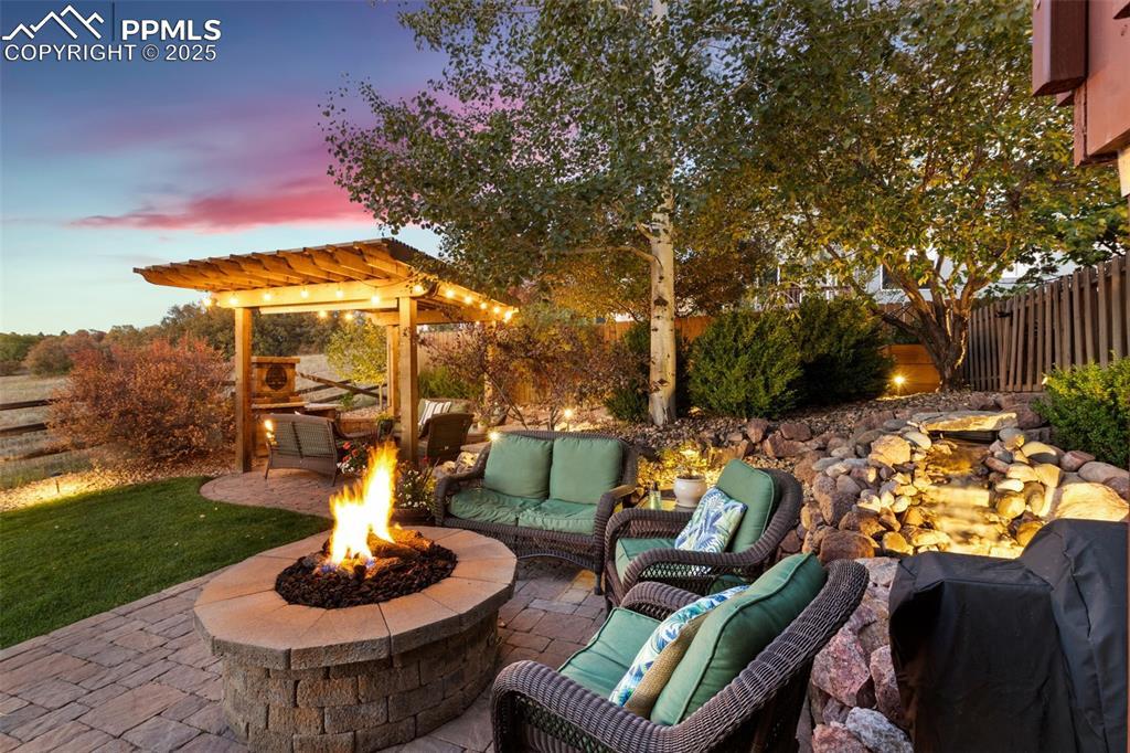 Image 2: View of patio / terrace featuring a pergola, water feature and outdoor lounge area