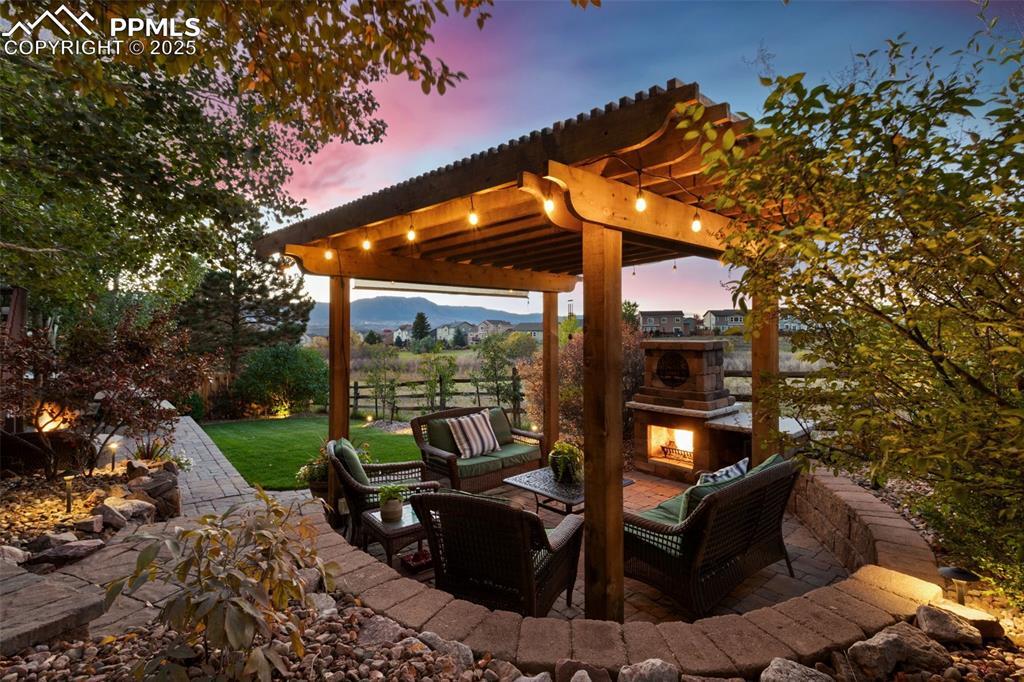 Image 3: View of patio / terrace featuring an outdoor living space with a fireplace and a mountain view