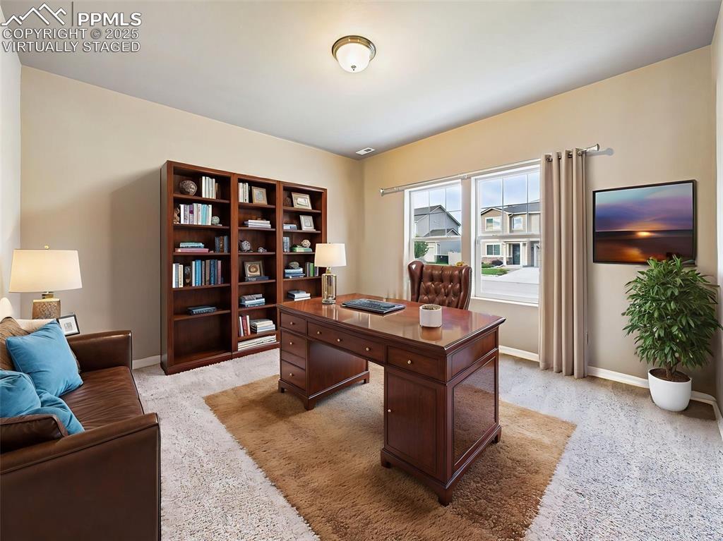Image 4: Virtually Staged - Shown here as a stylish home office with ample natural light and space for bookcases, seating, and a full executive desk setup.