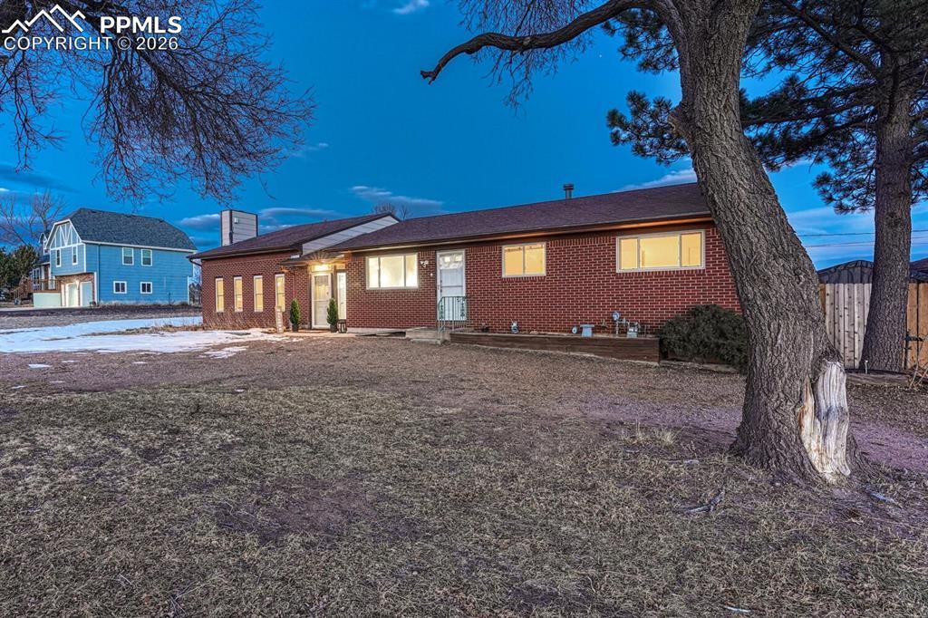 Image 2: Brick fronted home with lots of west facing windows and sweeping front ranch views.