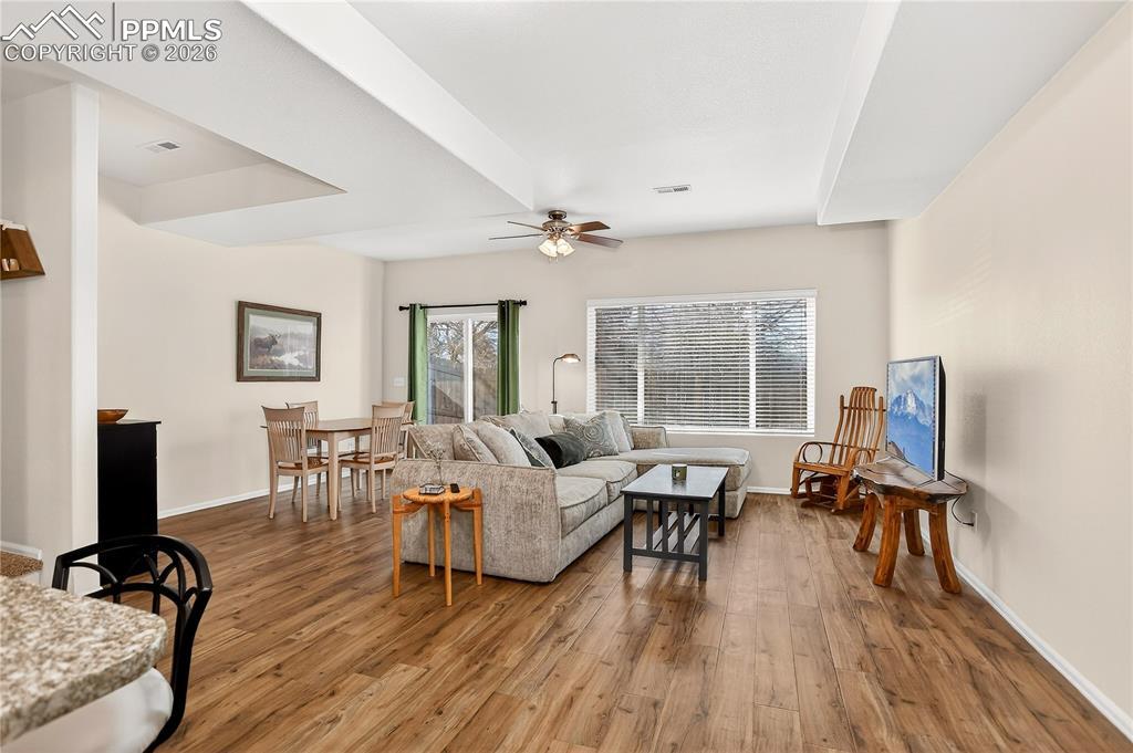 Image 3: View of living room from kitchen.