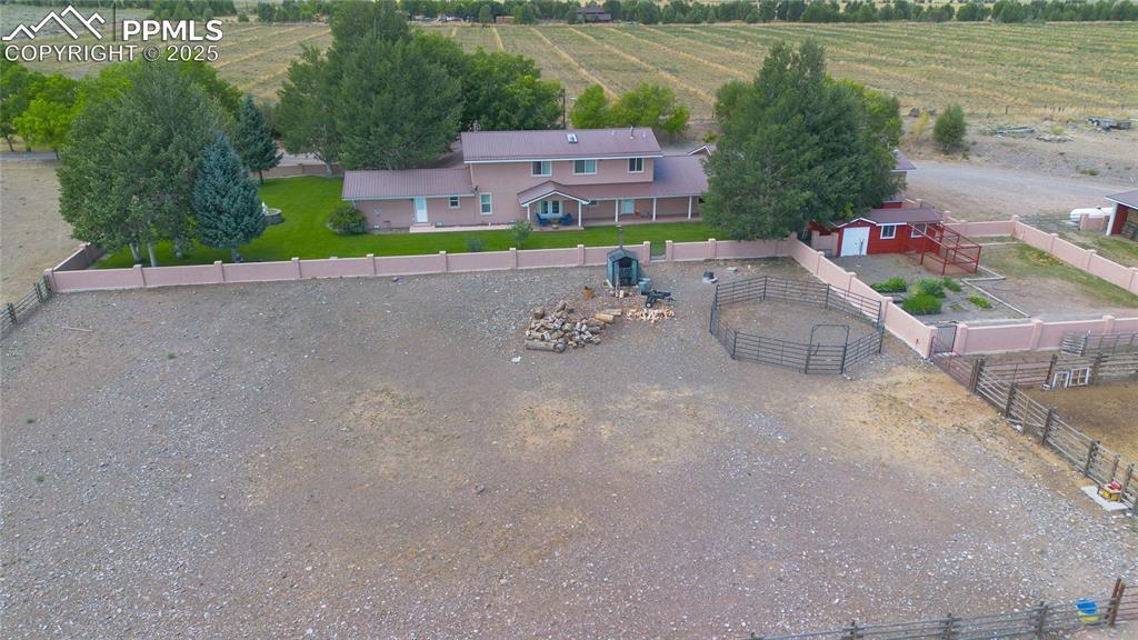 Image 4: Aerial view of sparsely populated area with rows of crops