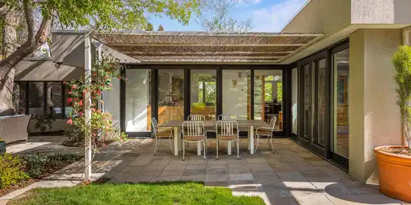 Image 3: The yard unfolds across expansive stone patios, grassy lawn, and terraced garden beds, with the Flatirons framed in full view above. Image 3: The yard unfolds across expansive stone patios, grassy lawn, and terraced garden beds, with the Flatirons framed in full view above.