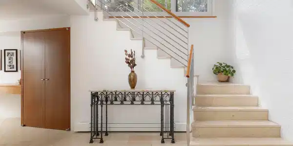 Image 4: The home today was designed with a European sensibility woven through every detail: the covered entry porch, the custom woodwork, the perimeter lighting, the built-in shelving that runs through room after room. Image 4: The home today was designed with a European sensibility woven through every detail: the covered entry porch, the custom woodwork, the perimeter lighting, the built-in shelving that runs through room after room.