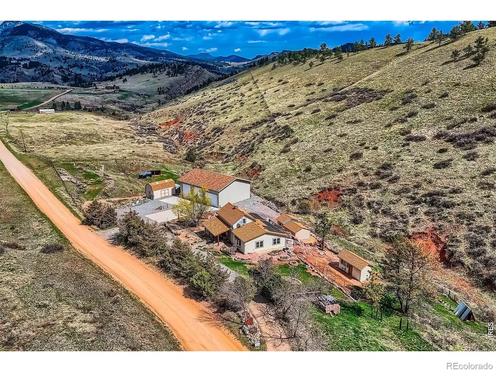 Image 1: Exterior Front with a backdrop of the expansive property