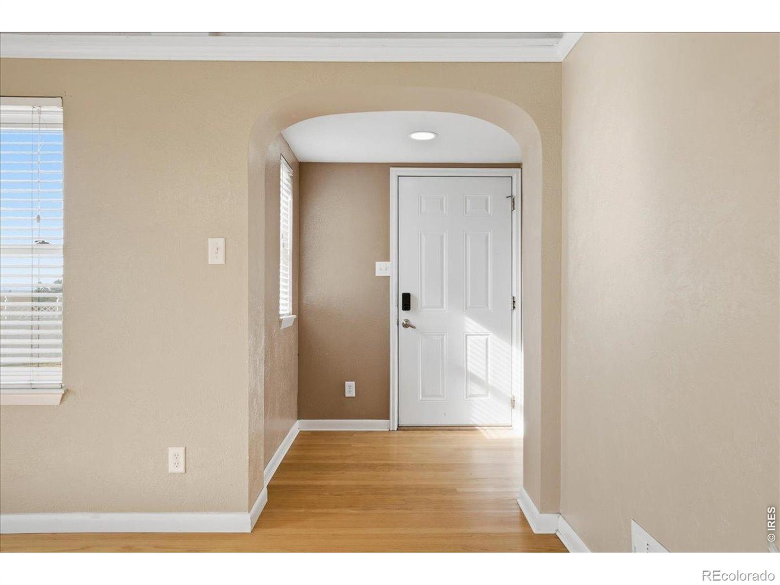 Image 2: This is the brick homes west door entry. Arched doorway and wood floors Image 2: This is the brick homes west door entry. Arched doorway and wood floors