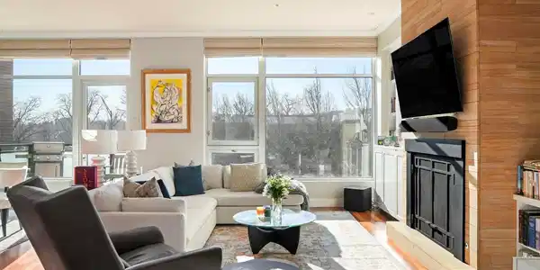 Image 2: The expansive, light-filled living room features a gas fireplace with Fieldstone surround. Image 2: The expansive, light-filled living room features a gas fireplace with Fieldstone surround.