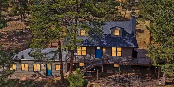 Image 2: Drone of the exterior and the wrap-around deck. Image 2: Drone of the exterior and the wrap-around deck.