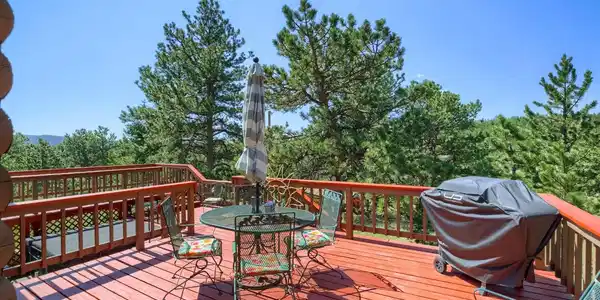 Image 3: Wrap-around decking offers loads of outdoor space to soak in the sunshine and enjoy the fresh mountain air.