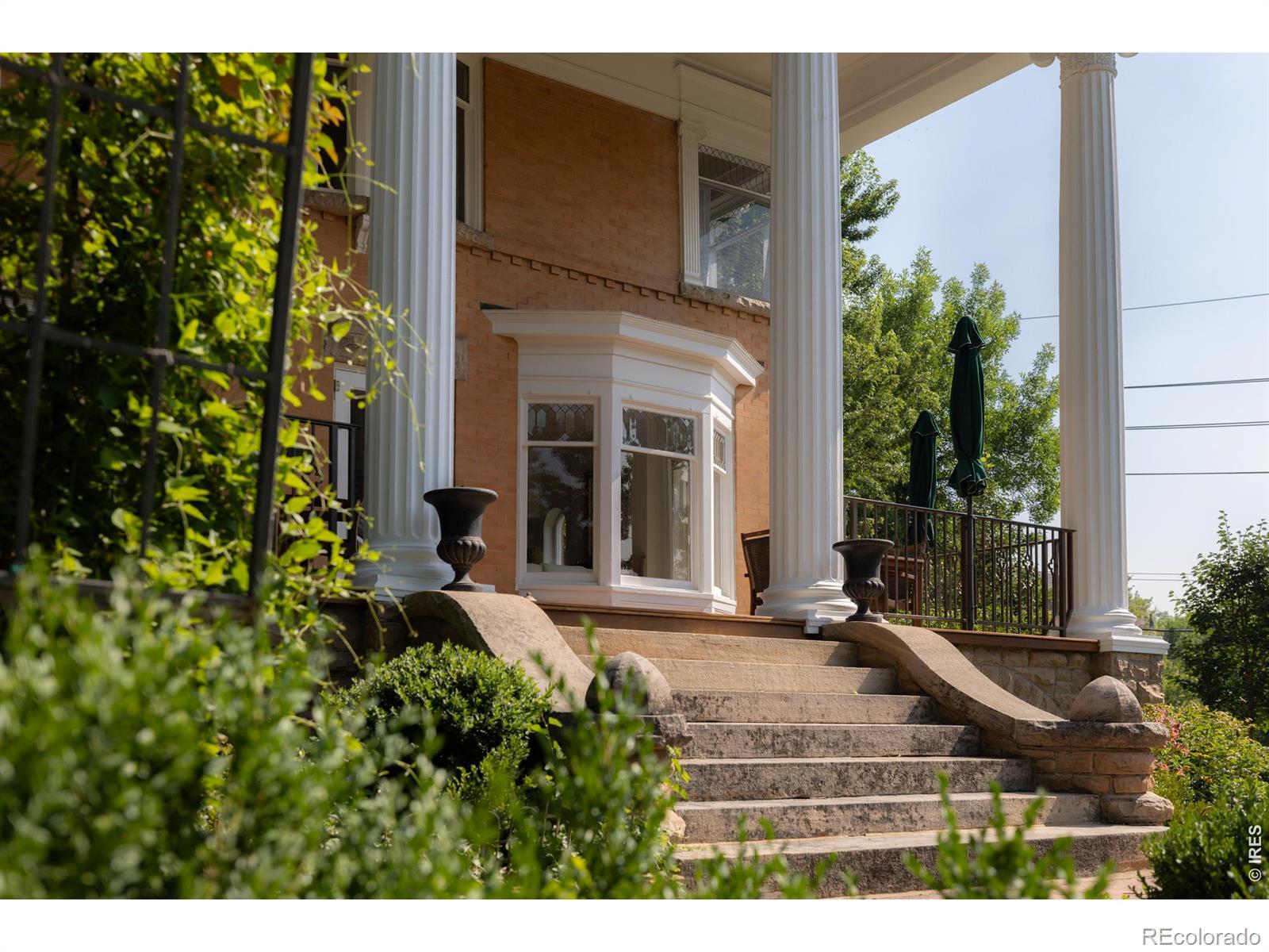 Image 2: Approaching the front porch, the homes elevated position and restored architectural details create a memorable arrival, with generous outdoor living overlooking the surrounding gardens. Image 2: Approaching the front porch, the homes elevated position and restored architectural details create a memorable arrival, with generous outdoor living overlooking the surrounding gardens.