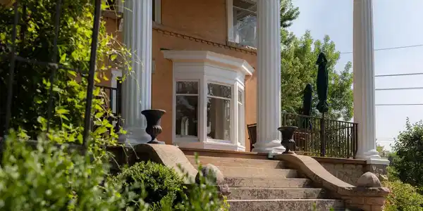 Image 2: Approaching the front porch, the homes elevated position and restored architectural details create a memorable arrival, with generous outdoor living overlooking the surrounding gardens. Image 2: Approaching the front porch, the homes elevated position and restored architectural details create a memorable arrival, with generous outdoor living overlooking the surrounding gardens.