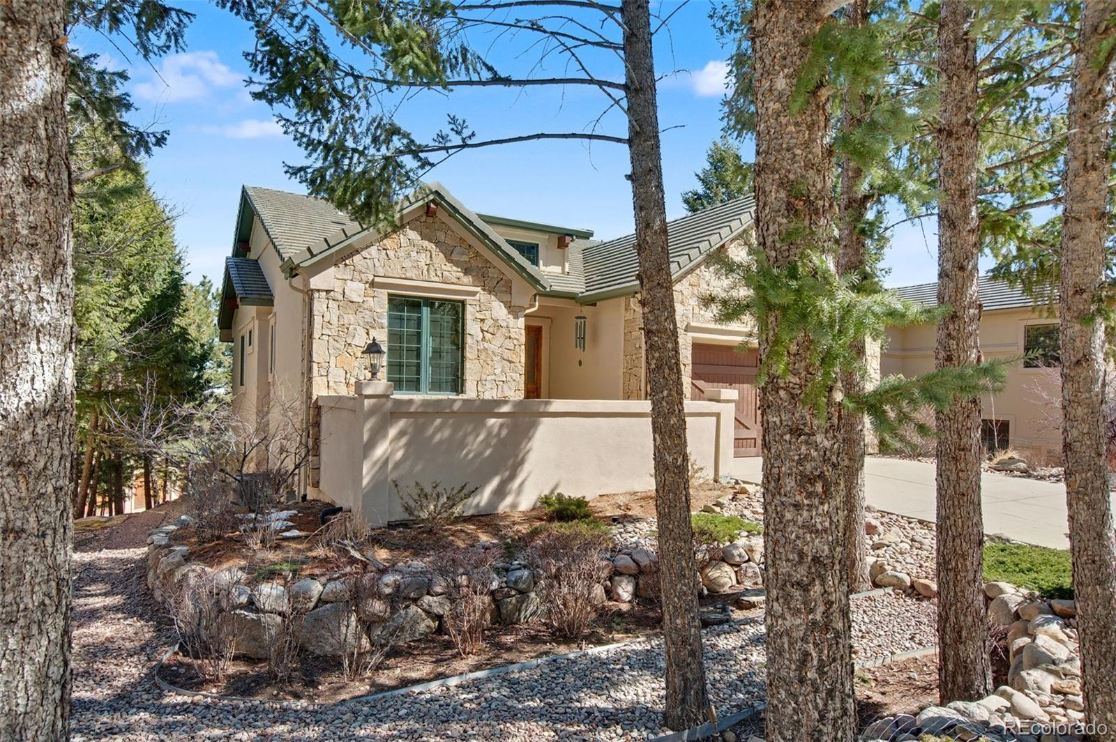 Image 3: Enjoy the front courtyard, surrounded by trees and views of the foothills