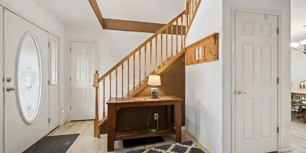 Image 2: Entryway leading to stairs, den/family room, and kitching & dining area. Image 2: Entryway leading to stairs, den/family room, and kitching & dining area.