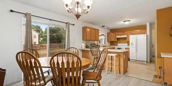 Image 4: View from dining area into kitchen. Behind kitchen wall is the laundry room and door to 2-car garage. Image 4: View from dining area into kitchen. Behind kitchen wall is the laundry room and door to 2-car garage.
