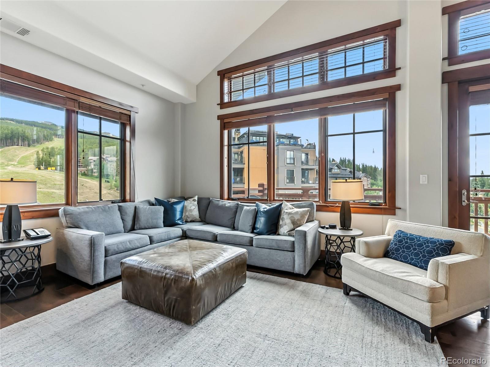 Image 4: Living room with wood finished floors and high vaulted ceiling
