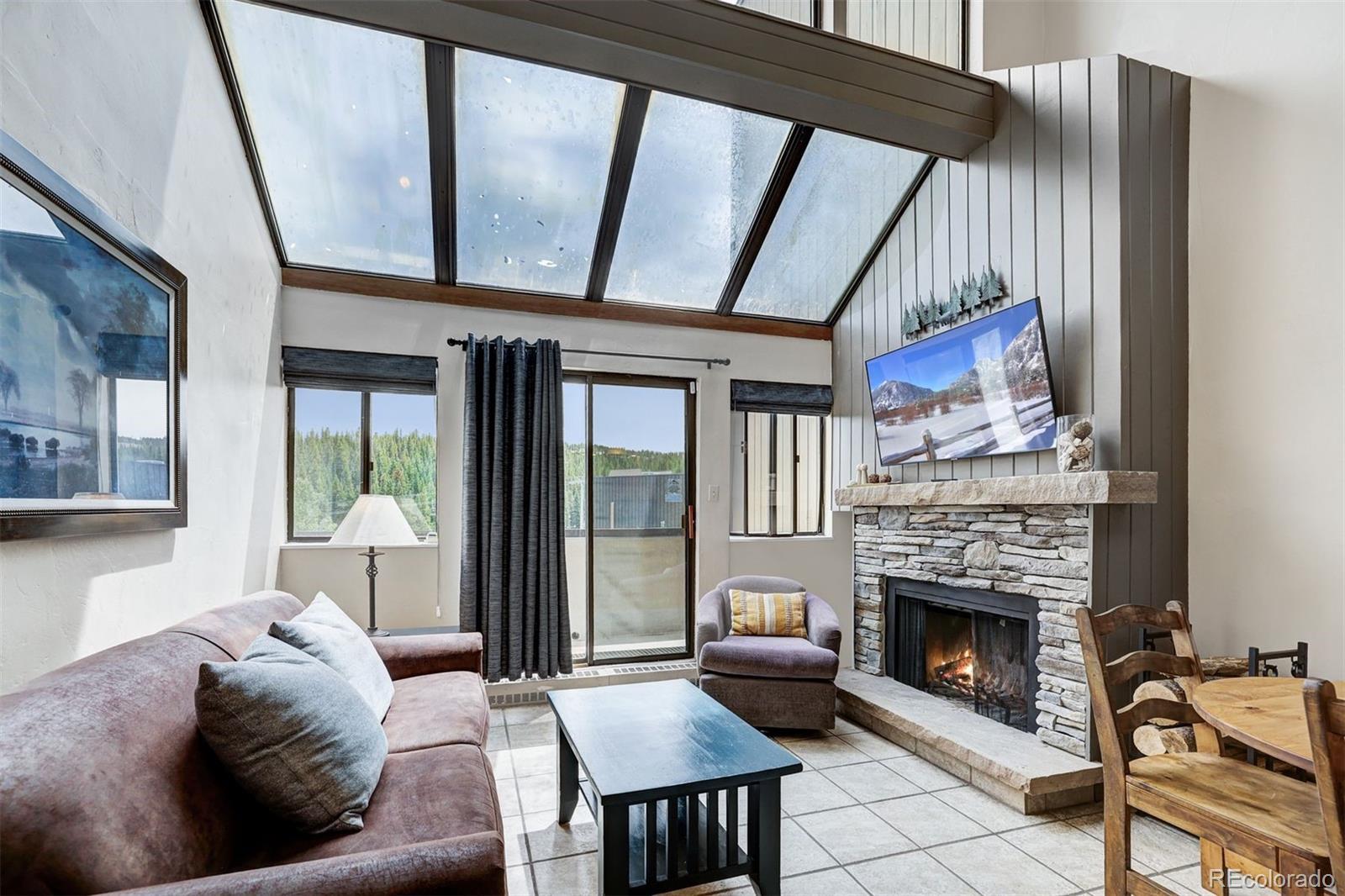 Image 1: Family room with an abundance of light, unobstructed ski mountain views and stone wood burning fireplace