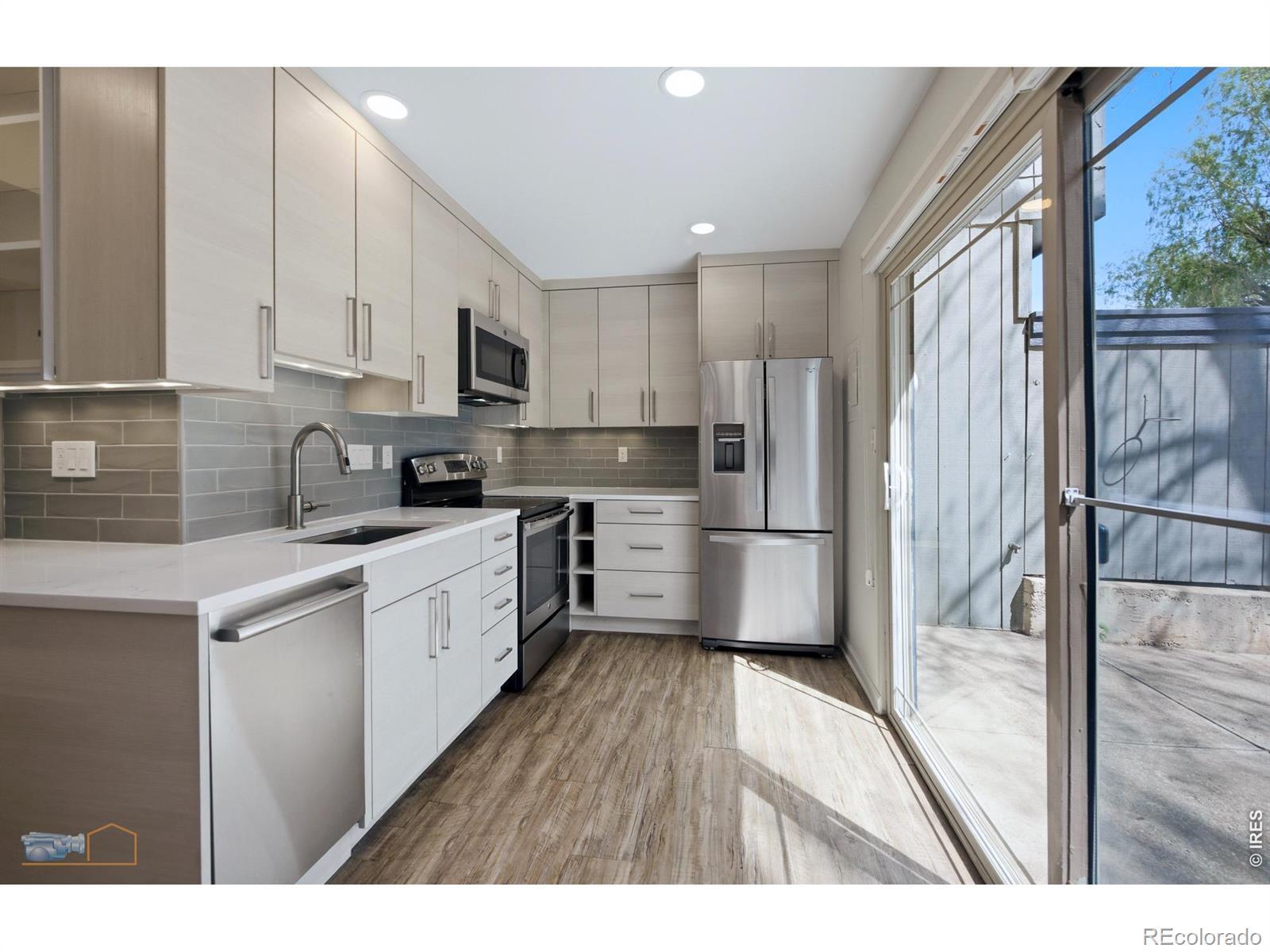 Image 1: Fully remodeled kitchen leads to private patio