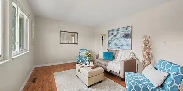 Image 4: Formal living room with abundant natural light from large picture windows.