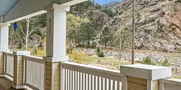 Image 2: Fish from your own property or simply relax and enjoy the stunning river and mountain views from the expansive covered front porch Image 2: Fish from your own property or simply relax and enjoy the stunning river and mountain views from the expansive covered front porch