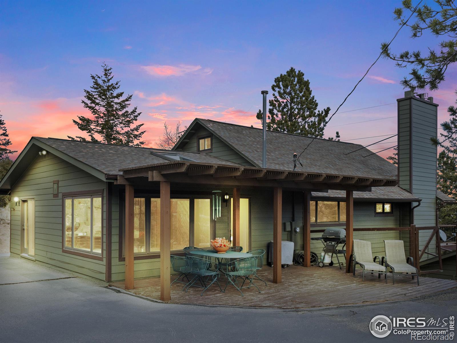 Image 4: Private covered dining space on the back deck, surrounded by rock outcroppings, mature trees and abundant wildlife.