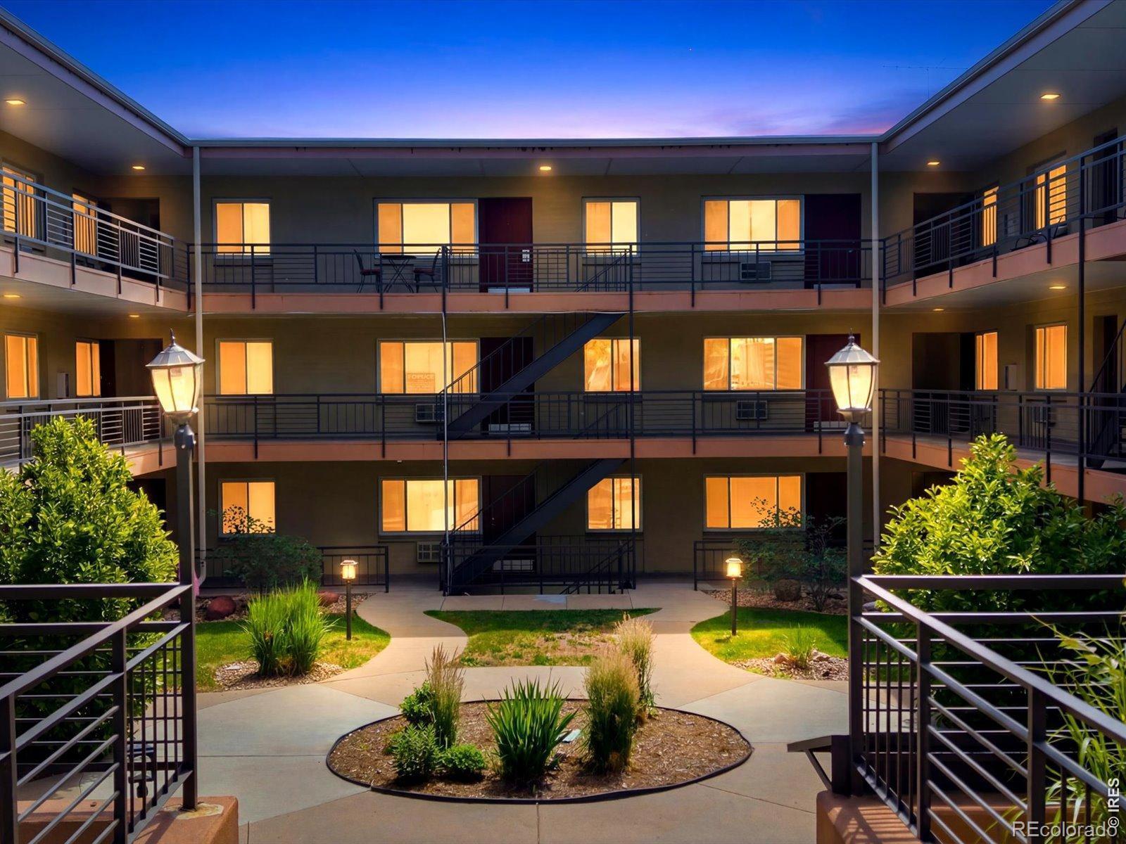 Image 1: Secure interior courtyard with landscaped walkways, ambient lighting, and a welcoming atmosphere. This well-maintained community offers a peaceful setting in the heart of University Hill.