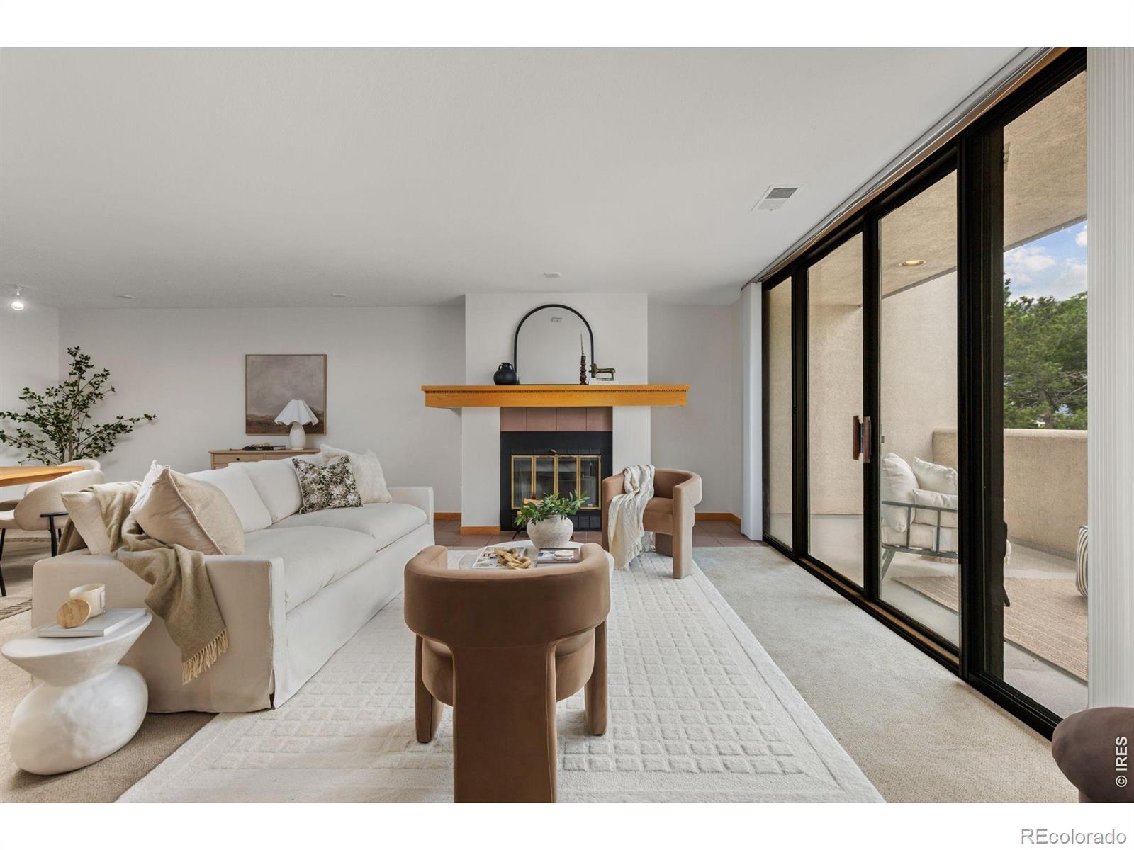 Image 4: Living area with wood-burning fireplace and spacious west-facing balcony with foothill views Image 4: Living area with wood-burning fireplace and spacious west-facing balcony with foothill views
