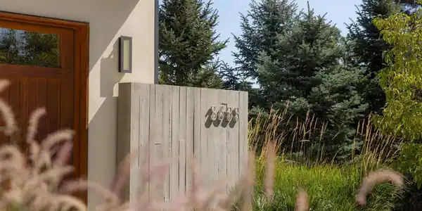 Image 2: Thoughtful landscaping and natural materials soften the homes modern architecture and create a welcoming sense of arrival. Image 2: Thoughtful landscaping and natural materials soften the homes modern architecture and create a welcoming sense of arrival.