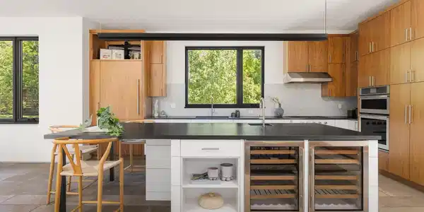 Image 3: Designed for serious cooking and easy entertaining, the kitchen features warm wood cabinetry, a substantial island, wine refrigeration and generous storage. Image 3: Designed for serious cooking and easy entertaining, the kitchen features warm wood cabinetry, a substantial island, wine refrigeration and generous storage.