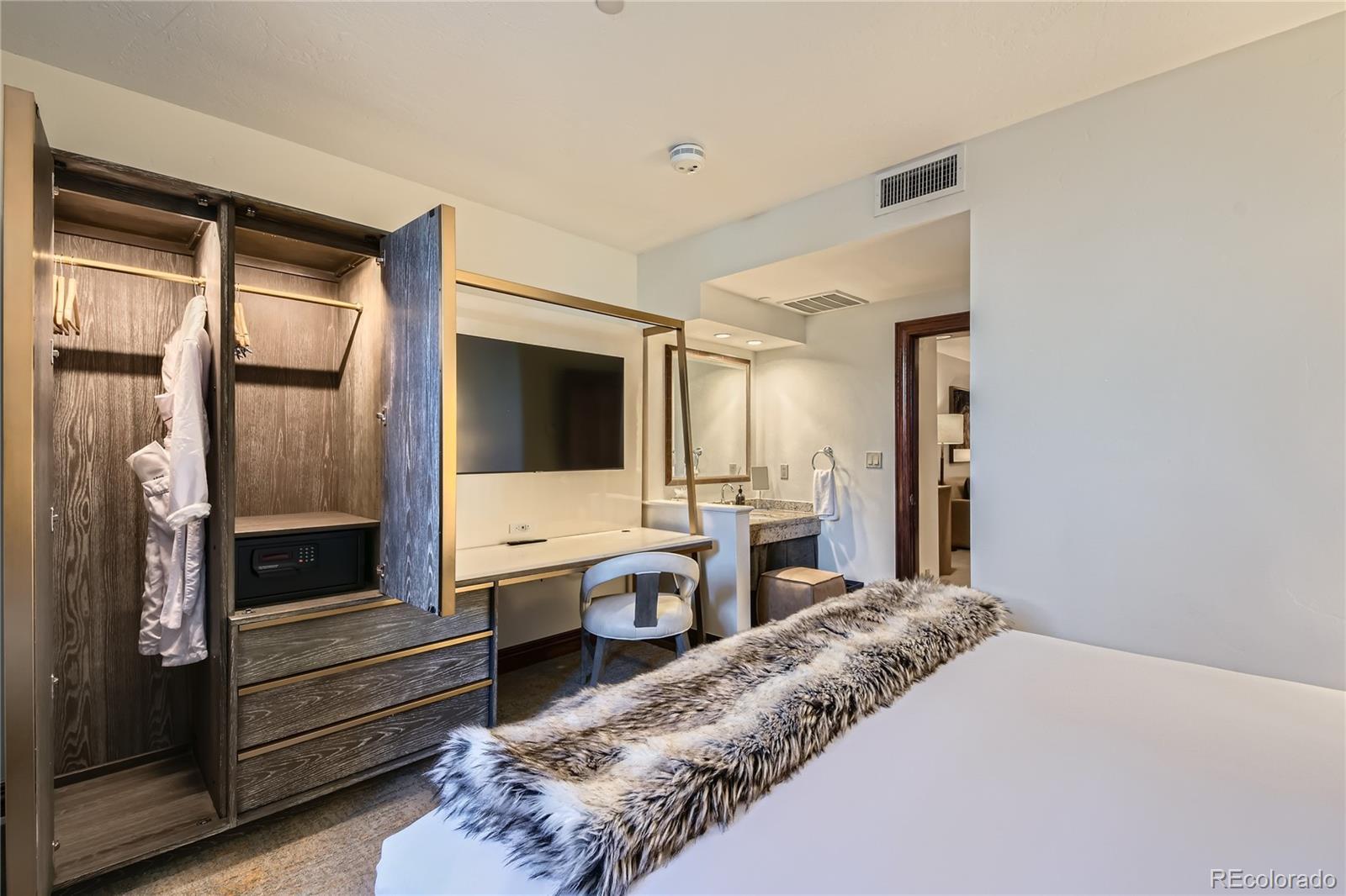 Image 2: Bedroom with desk and extra bathroom vanity