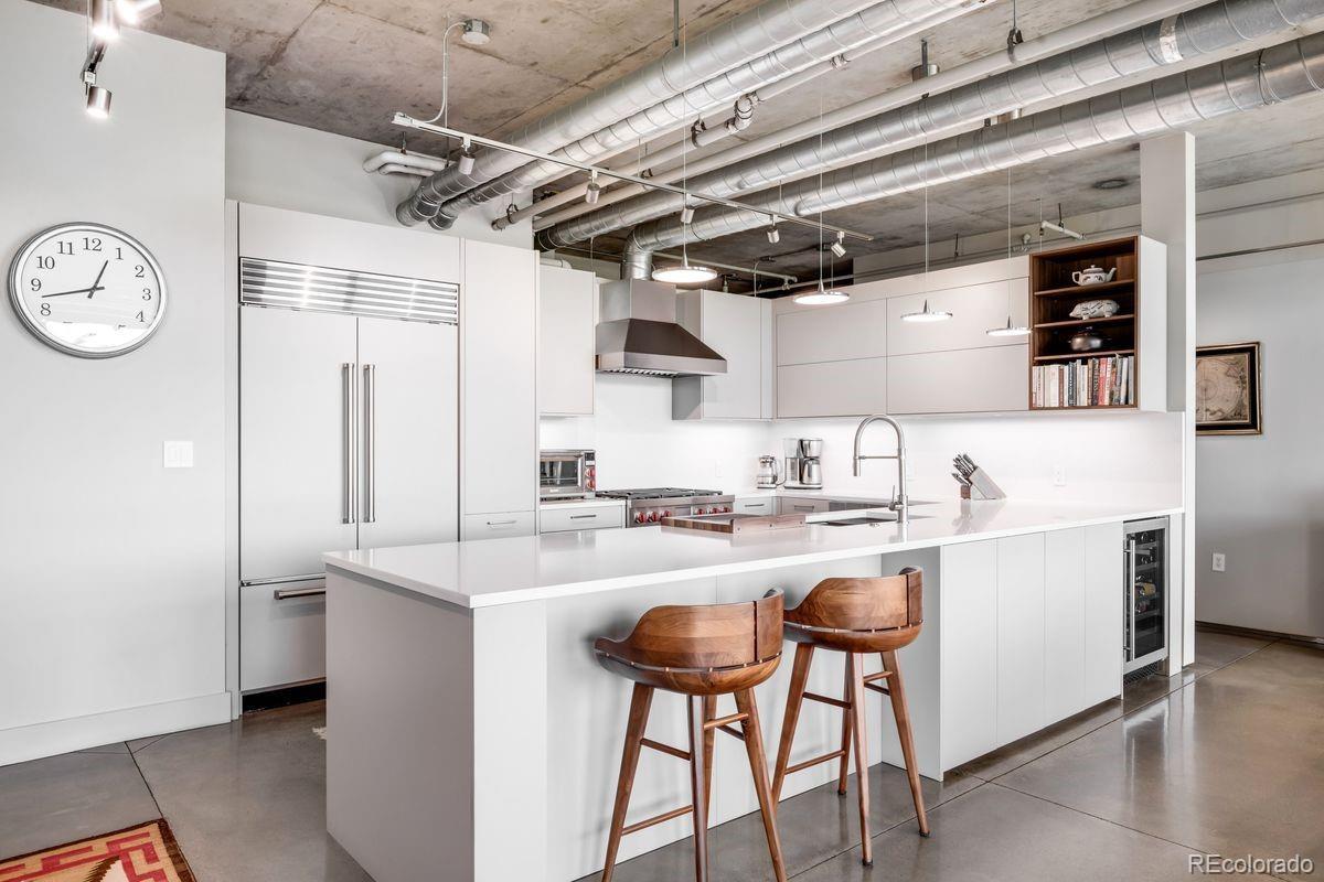 Image 4: New lighting throughout the residence casts a refined glow, enhancing the polished concrete floors that flow seamlessly throughout.