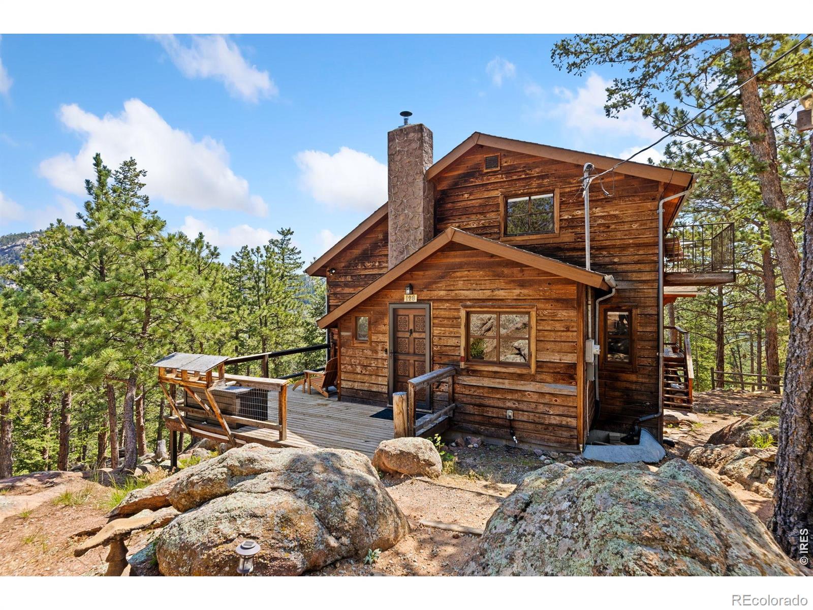 Image 2: Front door with deck and beautiful rock outcroppings Image 2: Front door with deck and beautiful rock outcroppings
